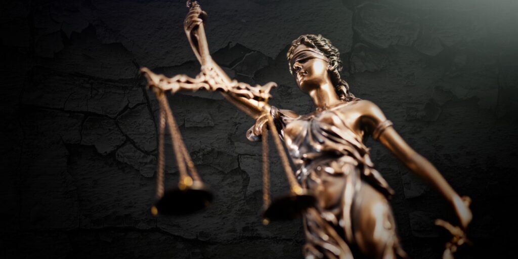 Justice statue of a woman holding scales and blindfolded