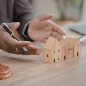 boundary lawyer explaining property boundaries using wooden building models