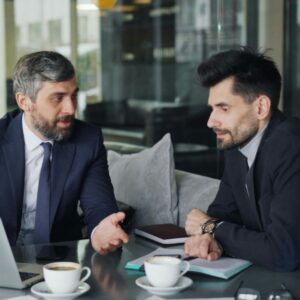 two businessmen reviewing a partnership agreement in an office