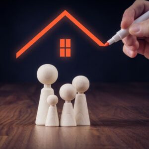 wooden model family with a hand drawing a roof over their heads