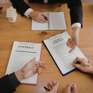 business partners signing contracts together